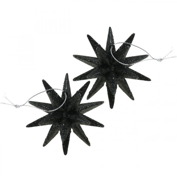 Zwei schwarze Sterne mit Glitzer als Baumschmuck