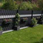 Doppelstabmattenzaun mit Pflanzenkästen in einem Garten