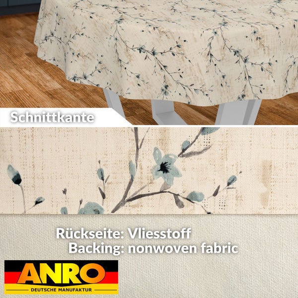 Rundes Wachstuch mit Blumenmuster auf einem Tisch, Detailansicht der Schnittkante und der Vliesstoff-Rückseite, ANRO Logo.