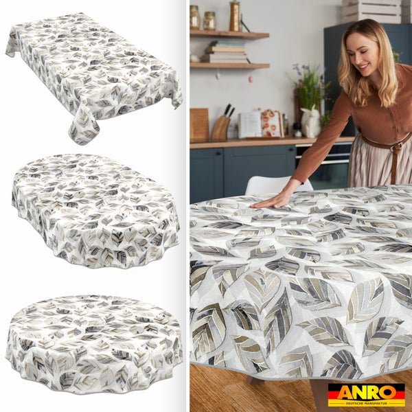 Tischdecke mit Blattmuster in rechteckiger, ovaler und runder Form sowie Frau beim Eindecken in einer hellen Küche. ANRO Deutsche Manufaktur Logo.