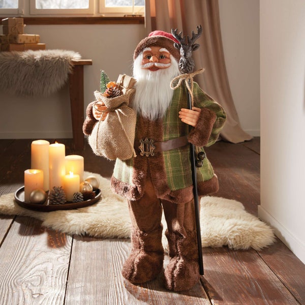 Dekorativer Weihnachtsmann mit Geschenkesack und Hirschkopfstock als festliche Dekoration
