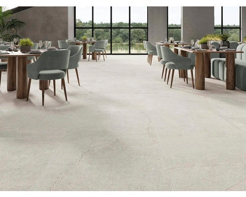 Heller Essbereich mit Tischen und Stühlen auf Fliesenboden