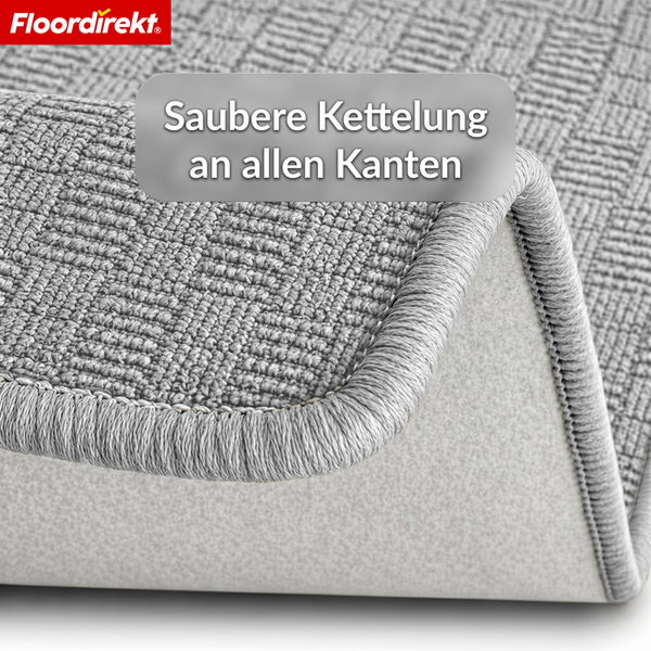 Nahaufnahme eines Teppichs mit sauberer Kettelung an den Kanten und gewebter Oberflächenstruktur. Floordirekt Logo.