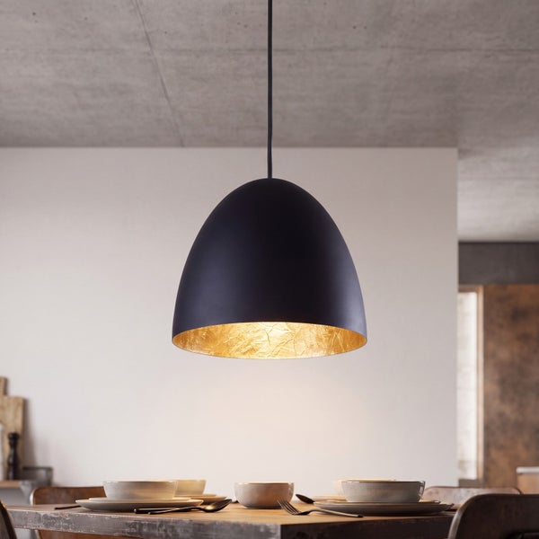 Moderne schwarze Pendelleuchte mit goldener Innenseite über einem gedeckten Holztisch in minimalistischem Raum.
