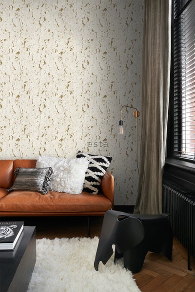 Wohnzimmer mit braunem Ledersofa, Kissen und gemusterter Tapete