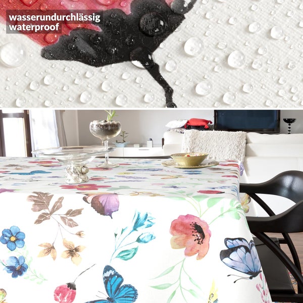 Wasserundurchlässige Tischdecke mit Blumen- und Schmetterlingsmuster, Detailansicht mit Wassertropfen und Anwendungsbeispiel im Wohnzimmer.