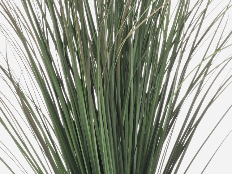 Detailansicht von künstlichem Gras mit langen, schmalen grünen Halmen.