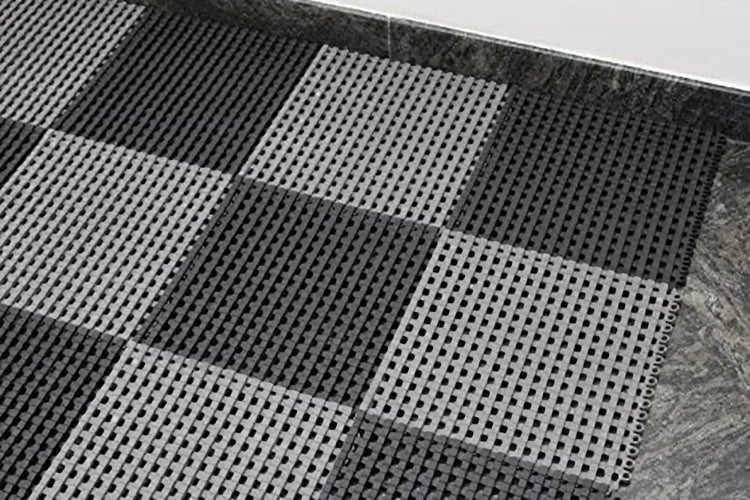 Bodenfliesen aus Kunststoff mit gitterartigem Design in Schachbrettanordnung als rutschfester Belag für den Innen und Außenbereich