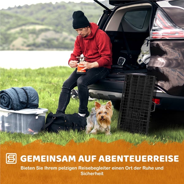 Mann bereitet Campingkocher neben seinem Hund und einem Auto vor
