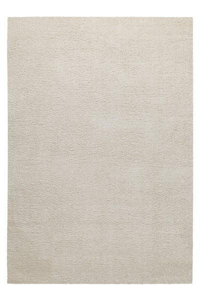 Rechteckiger Hochflor-Teppich in Beige mit weicher, flauschiger Struktur.