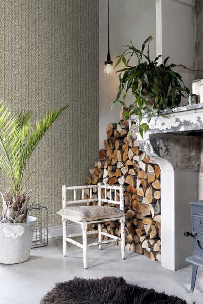 Dekorativer Wohnraum mit gemusterter Tapete, Kaminholz und Zimmerpflanzen für eine gemütliche Atmosphäre