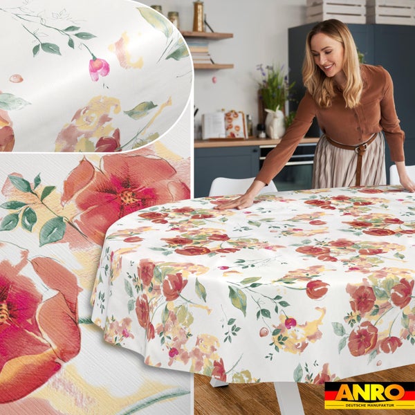 Runde Wachstuch-Tischdecke mit Blumenmuster in Aquarell-Optik auf einem Küchentisch, Detailansicht der Struktur, ANRO Deutsche Manufaktur Logo.
