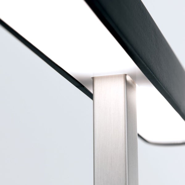 Detailansicht einer Lampe mit Metallsockel und schwarzem Lampenschirm