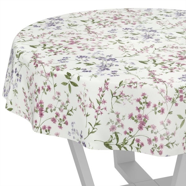 Runde Tischdecke mit floralem Muster auf einem Tisch.