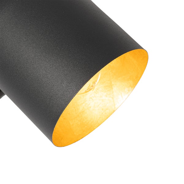 Nahaufnahme einer schwarzen Lampe mit goldener Innenseite