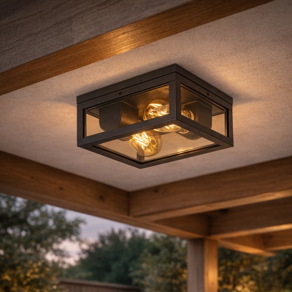 Moderne quadratische Außen-Deckenleuchte aus Metall und Glas mit zwei leuchtenden Filament-Leuchtmitteln montiert an einer Decke mit Holzbalken.