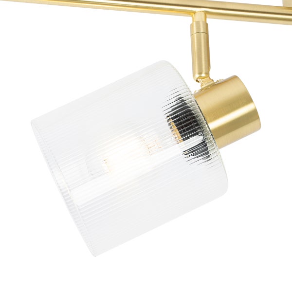 Detailaufnahme einer Messing-Strahlerlampe mit geripptem Glasschirm.