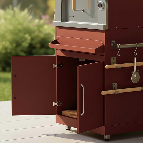 Pizzaofen für den Außenbereich mit offenem Unterschrank, seitlichen Haken für Zubehör und integriertem Thermometer.