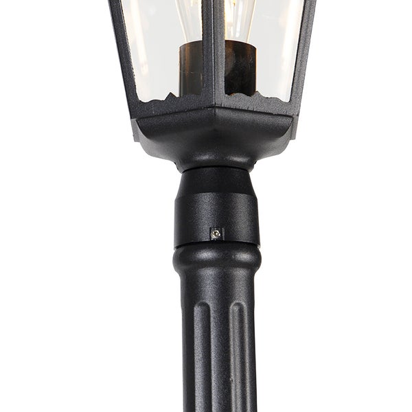 Detailansicht einer schwarzen Mastleuchte für den Außenbereich mit geriffeltem Rohr und Glaseinsätzen.