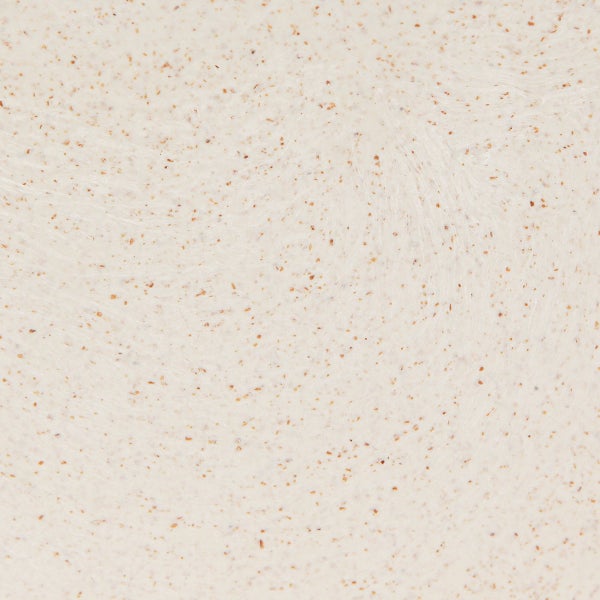 Nahaufnahme einer beige Arbeitsplatte mit braunen Sprenkeln.