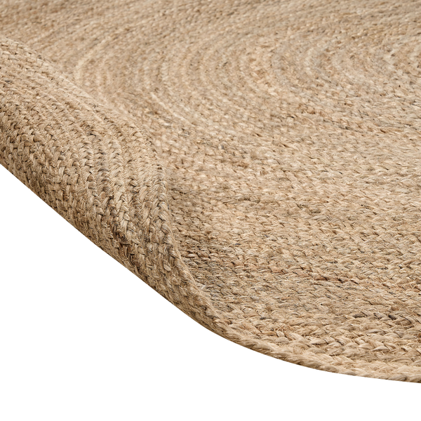 Nahaufnahme eines runden Jute-Teppichs mit geflochtener Textur und Spiralmuster.