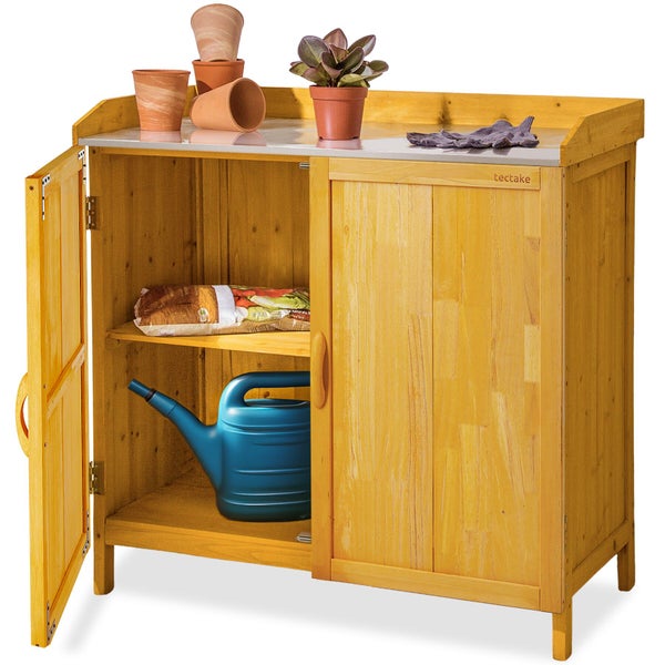 Pflanztisch aus Holz mit verzinkter Arbeitsfläche und zwei Türen, befüllt mit Gartenutensilien, tectake Logo.