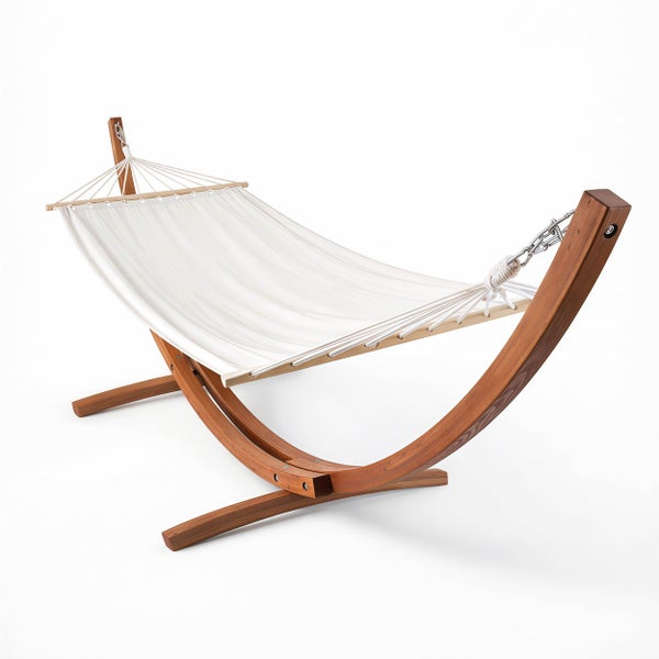 Hängematte mit weißem Stoff und einem gebogenen Gestell aus Holz.