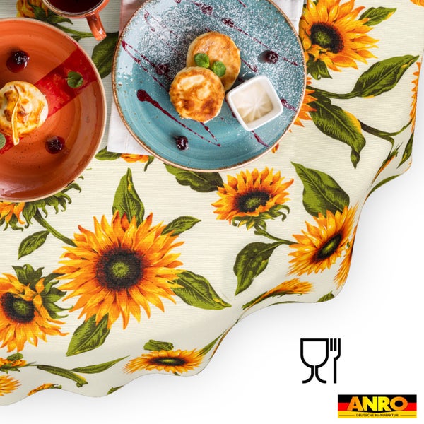 Abwaschbare Tischdecke mit Sonnenblumenmuster und grünen Blättern, geeignet für den Kontakt mit Lebensmitteln, ANRO Deutsche Manufaktur Logo.