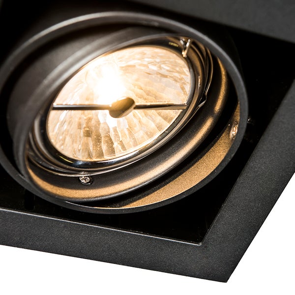 Nahaufnahme eines verstellbaren Einbaustrahlers mit warmweißem Leuchtmittel und schwarzem Metallrahmen.