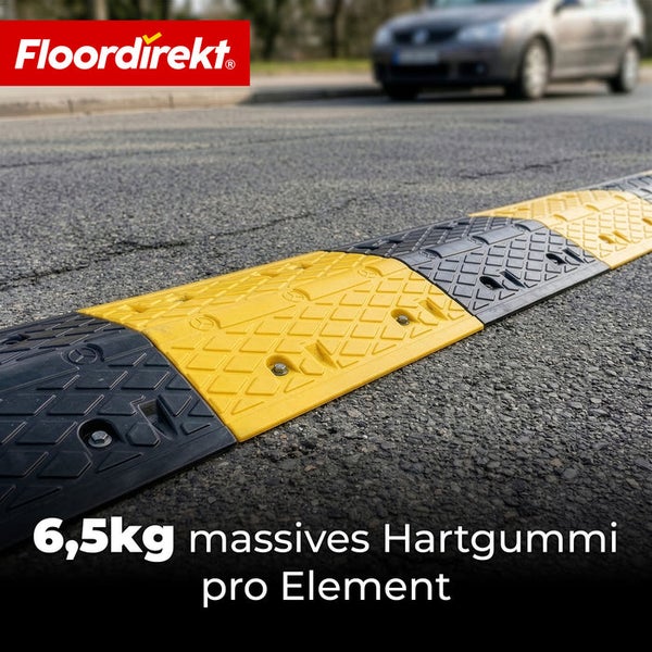 Floordirekt Logo. Fahrbahnschwelle aus massivem Hartgummi, 6,5 Kilogramm pro Element, gelb und schwarz, strukturiert, auf Asphalt montiert.