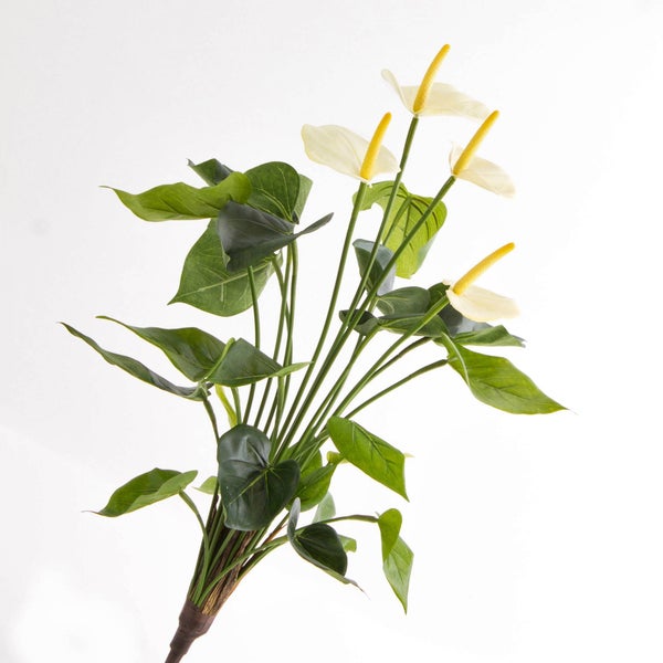 Künstliche Anthurie mit weißen Blüten und grünen Blättern.