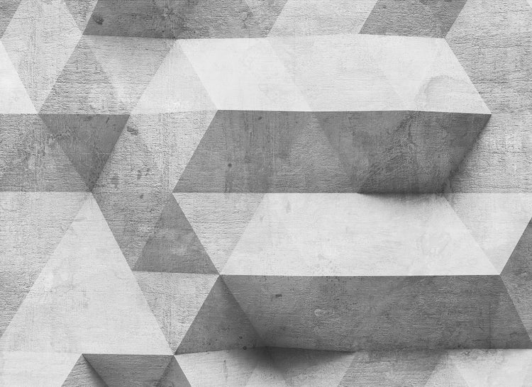 Tapete mit geometrischem 3D-Muster in Betonoptik aus Dreiecken und Trapezformen mit rauer Struktur.