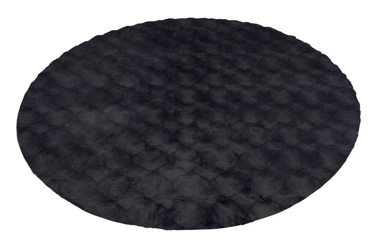 Runder Hochflor Teppich mit strukturierter Oberfläche.