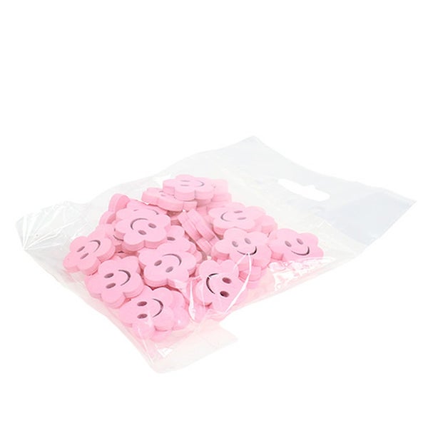 Dekorative Holzblumen mit Gesicht in einer Verpackung