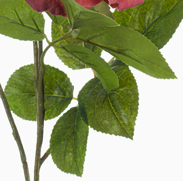 Nahaufnahme einer Kunstblume mit grünen Blättern und Stiel für die Innendekoration.