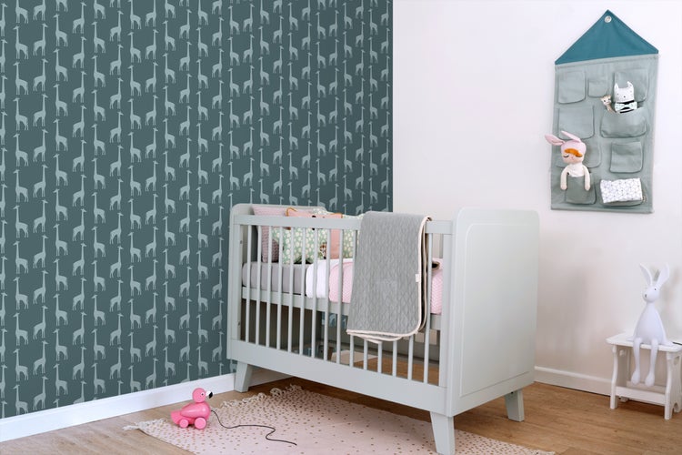 Kinderzimmer mit Gitterbett, Wandtapete mit Giraffenmuster und Wandorganizer