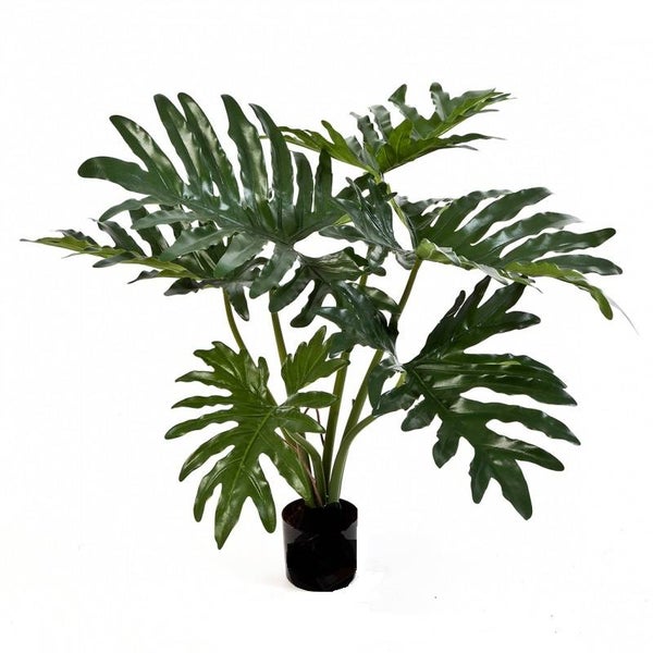 Künstliche Pflanze Philodendron Selloum mit grünen Blättern in einem schwarzen Topf.