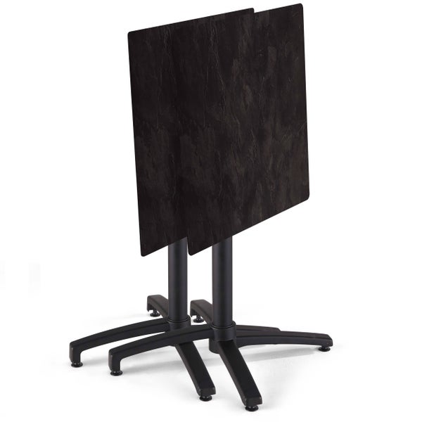 Zwei Bistrotische mit quadratischen Platten in Steinoptik, hochgeklappt, auf schwarzen Vierfußgestellen.