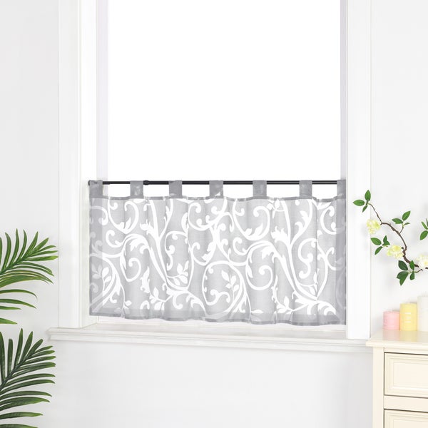 Gardine mit Schlaufen und floralem Muster vor einem Fenster