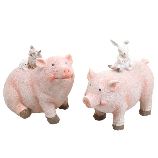 Zwei dekorative Schweinefiguren mit Vogel- und Hasenfiguren