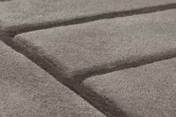 Detailansicht eines strukturierten Badteppichs mit erhabenem Rillenmuster aus weichem Textilmaterial