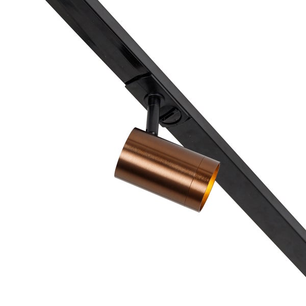 Moderner zylindrischer Strahler in Bronze aus gebürstetem Metall an einem schwarzen Schienensystem.