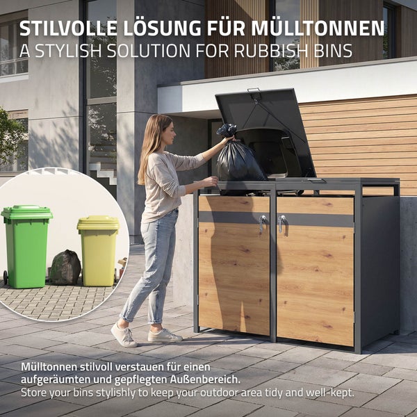 Person füllt einen Müllsack in eine moderne Mülltonnenbox aus Metall und Holz vor einem Haus für einen gepflegten Außenbereich.