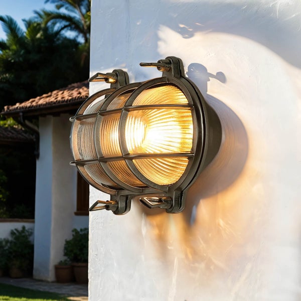 Runde Außenwandleuchte mit Käfig an einer Wand