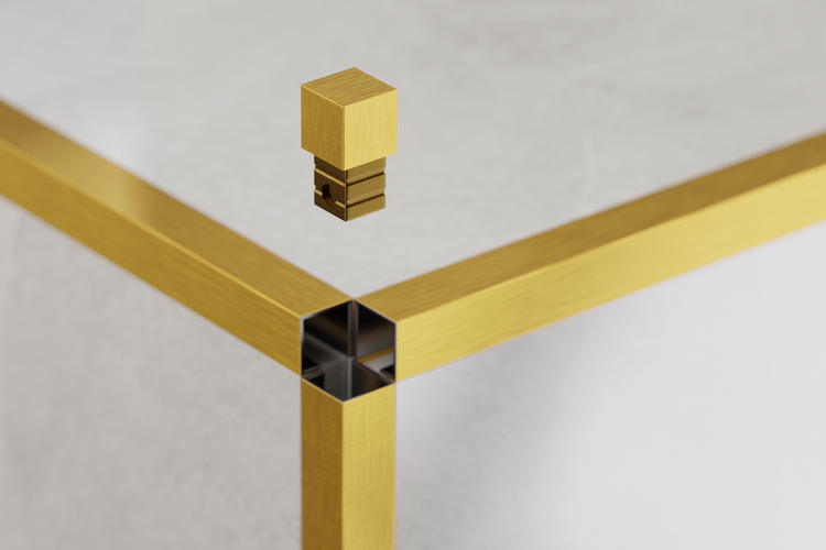 Detailansicht eines goldenen Tischgestells mit einem Verbindungselement