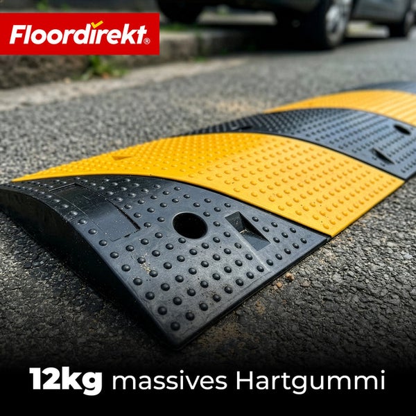 Floordirekt Logo. Fahrbahnschwelle aus 12 Kilogramm massivem Hartgummi auf Asphalt mit profilierter Oberfläche.