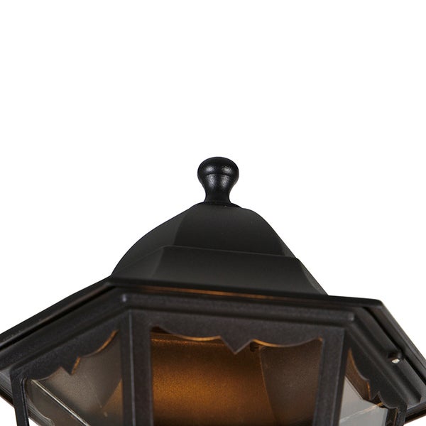 Detailansicht des oberen Teils einer schwarzen Außenleuchte mit dekorativem Abschluss und Glaseinsätzen.