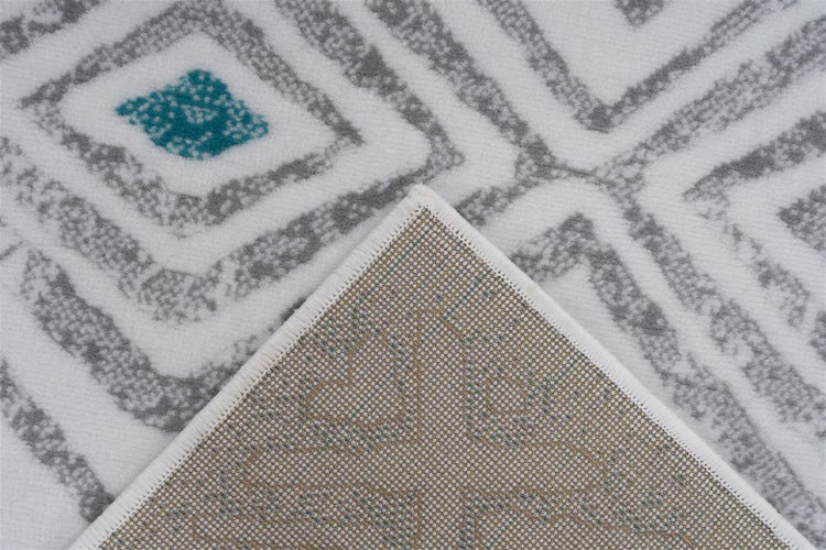 Teppich mit geometrischem Rautenmuster und sichtbarer Rückseite mit Kettelung