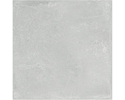 Quadratische Feinsteinzeugfliese in grauer Betonoptik mit matter Oberfläche.