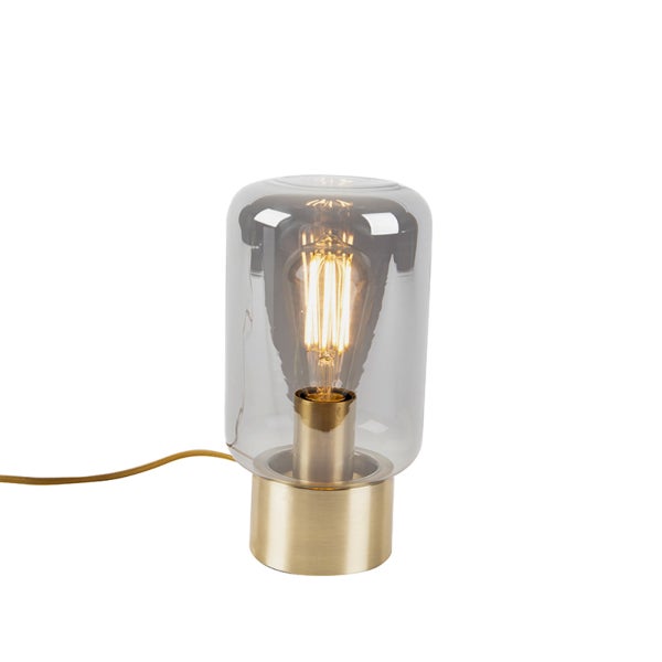 Tischleuchte mit zylinderförmigem Rauchglasschirm und sichtbarem Leuchtmittel auf einem Messingfuß.